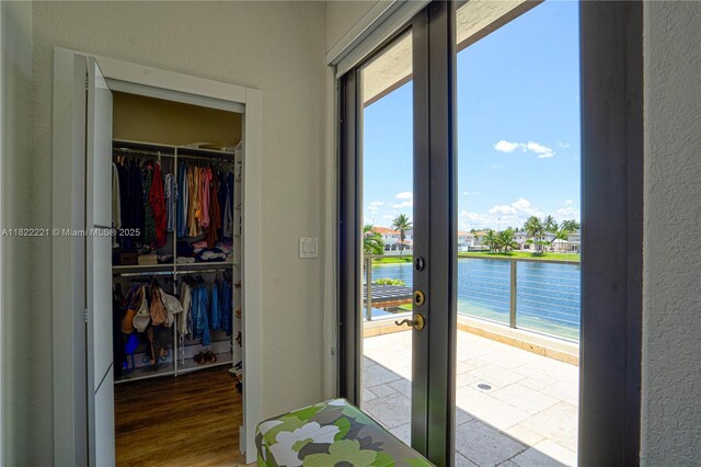 8965 NW 174th Ln, Hialeah, FL 33018 - doorway with a water view, french doors, and a textured wall