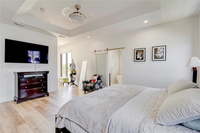 8965 NW 174th Ln, Hialeah, FL 33018 - bedroom featuring a barn door, a tray ceiling, light wood finished floors, and recessed lighting