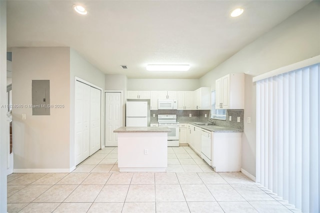2903 SE 15th Ter, Homestead, FL 33035 - kitchen featuring white appliances, a kitchen island, electric panel, light countertops, and light tile patterned floors