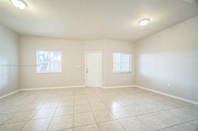 2903 SE 15th Ter, Homestead, FL 33035 - empty room featuring a textured ceiling, plenty of natural light, and light tile patterned floors