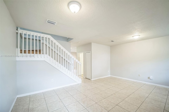 2903 SE 15th Ter, Homestead, FL 33035 - unfurnished room with a textured ceiling, stairs, and tile patterned flooring