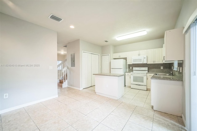 2903 SE 15th Ter, Homestead, FL 33035 - kitchen featuring white appliances, a center island, electric panel, light tile patterned flooring, and white cabinetry