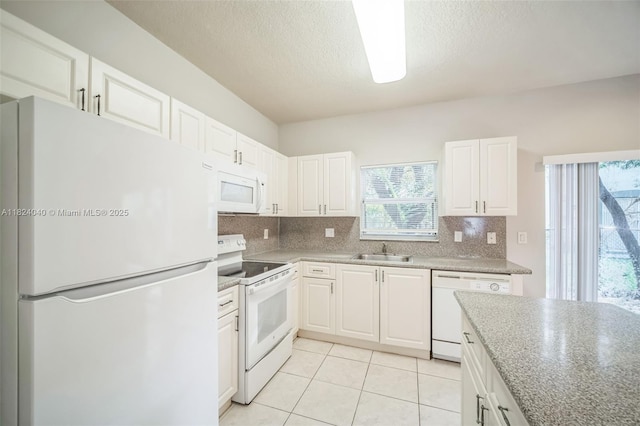 2903 SE 15th Ter, Homestead, FL 33035 - kitchen featuring white appliances, decorative backsplash, white cabinetry, and a textured ceiling