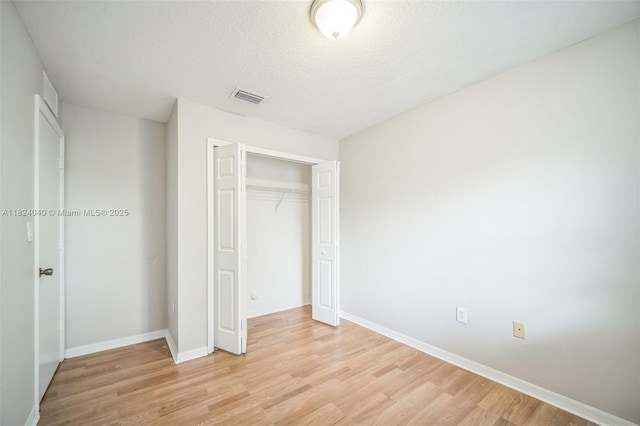 2903 SE 15th Ter, Homestead, FL 33035 - unfurnished bedroom featuring light wood finished floors, a closet, and a textured ceiling