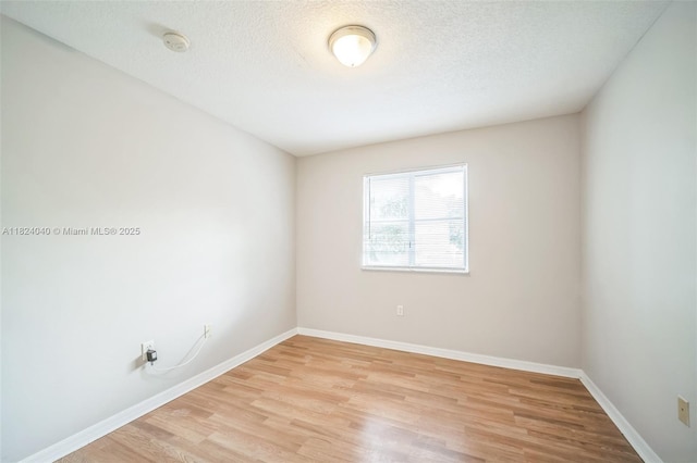 2903 SE 15th Ter, Homestead, FL 33035 - spare room with a smoke detector, light wood-style floors, and a textured ceiling
