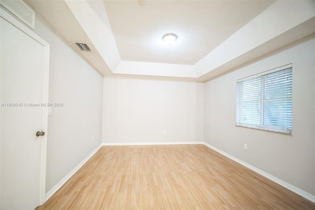 2903 SE 15th Ter, Homestead, FL 33035 - spare room with a tray ceiling and wood finished floors