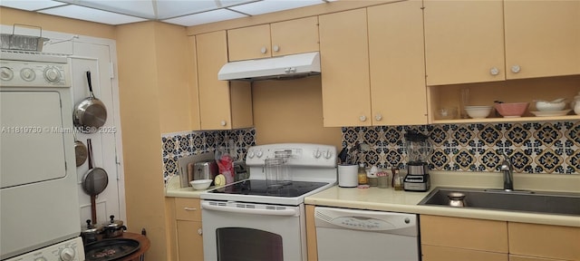 3475 S Ocean Blvd Unit 611, Palm Beach, FL 33480 - kitchen featuring stacked washer / dryer, white appliances, under cabinet range hood, light countertops, and backsplash