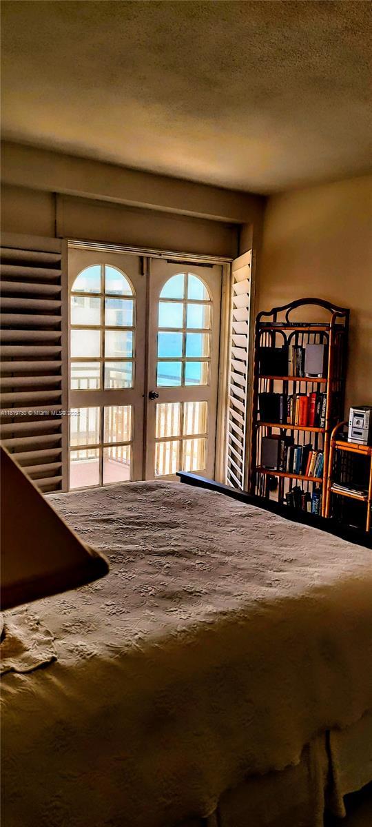 3475 S Ocean Blvd Unit 611, Palm Beach, FL 33480 - bedroom featuring french doors and a textured ceiling
