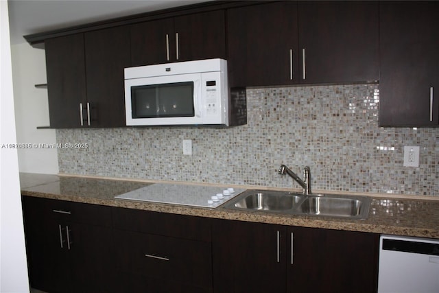 2930 Point E Dr Unit E309, Aventura, FL 33160 - kitchen featuring white appliances, backsplash, dark brown cabinetry, and light stone countertops