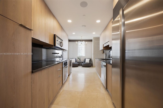 901 Brickell Key Blvd Unit 2506, Miami, FL 33131 - kitchen featuring stainless steel appliances, modern cabinets, dark countertops, a chandelier, and recessed lighting