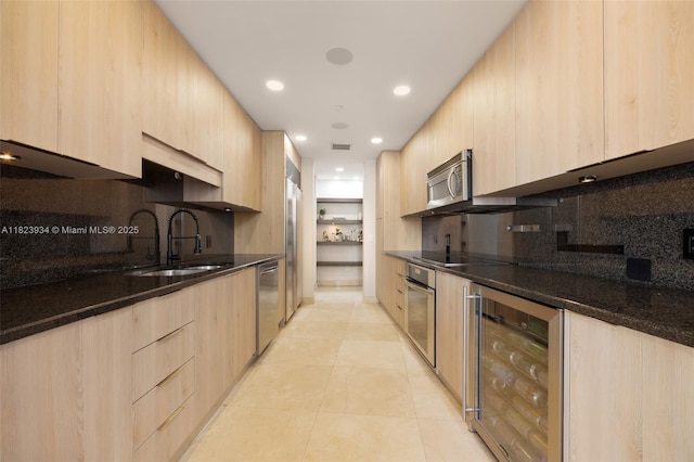 901 Brickell Key Blvd Unit 2506, Miami, FL 33131 - kitchen with light brown cabinets, modern cabinets, beverage cooler, appliances with stainless steel finishes, and tasteful backsplash