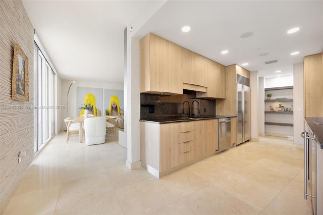 901 Brickell Key Blvd Unit 2506, Miami, FL 33131 - kitchen with appliances with stainless steel finishes, light brown cabinets, dark countertops, modern cabinets, and tasteful backsplash