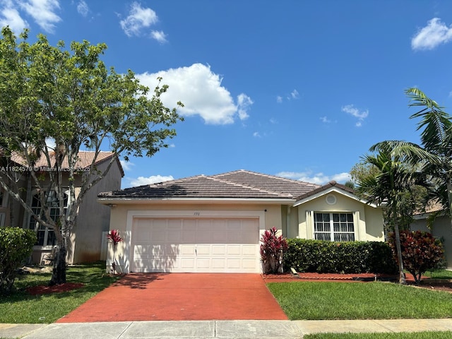 530 SW 182nd Way, Pembroke Pines, FL 33029 - view of front of property with concrete driveway, a garage, stucco siding, and a front lawn