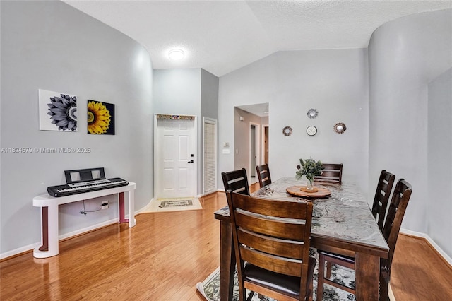 530 SW 182nd Way, Pembroke Pines, FL 33029 - dining area with vaulted ceiling, wood finished floors, and a textured ceiling
