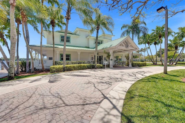 530 SW 182nd Way, Pembroke Pines, FL 33029 - view of front of house with covered porch, a metal roof, and a front yard