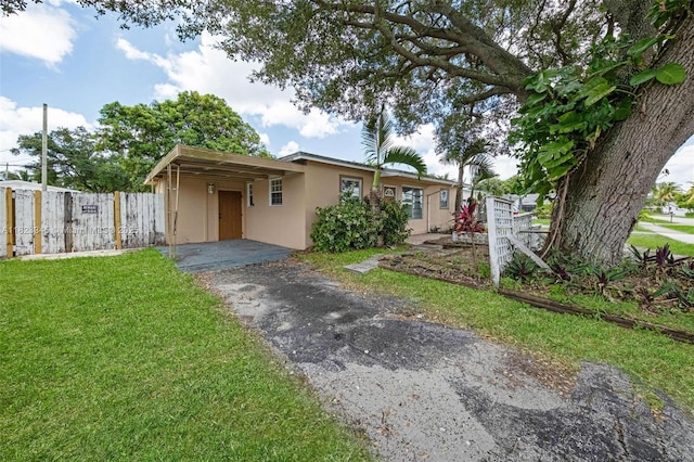 4625 SW 32nd Dr, West Park, FL 33023 - view of front of property with stucco siding, asphalt driveway, and an attached carport