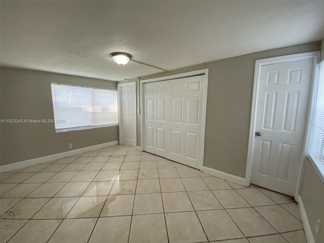 4625 SW 32nd Dr, West Park, FL 33023 - unfurnished bedroom featuring light tile patterned flooring, multiple windows, and a closet