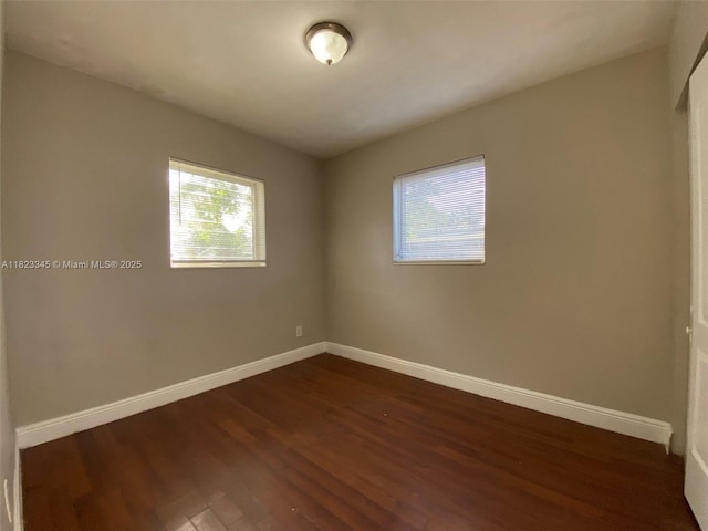 4625 SW 32nd Dr, West Park, FL 33023 - spare room with dark wood-style floors and baseboards