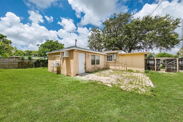 4625 SW 32nd Dr, West Park, FL 33023 - back of house featuring stucco siding, a fenced backyard, and an AC wall unit