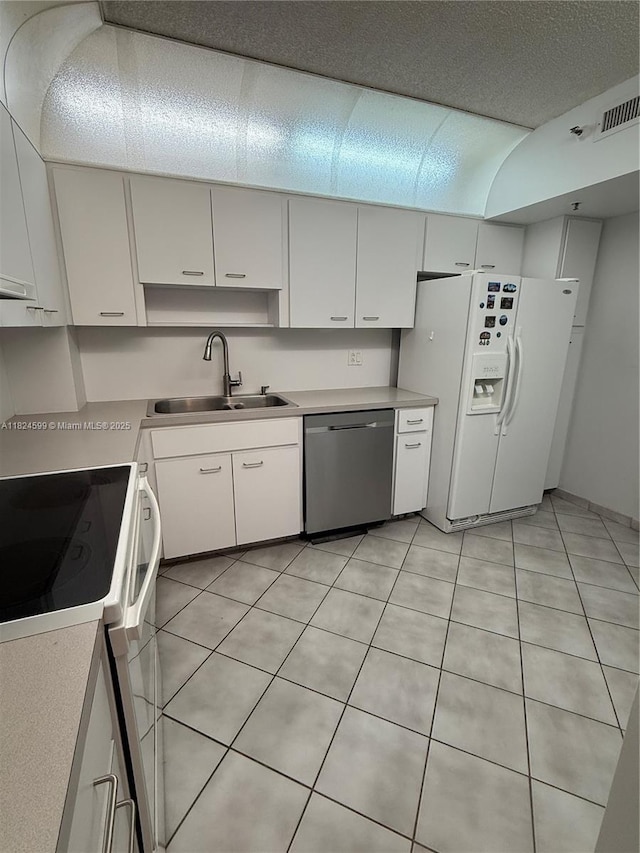 4001 Hillcrest Dr Unit 710, Hollywood, FL 33021 - kitchen featuring white appliances, light countertops, light tile patterned floors, and white cabinets