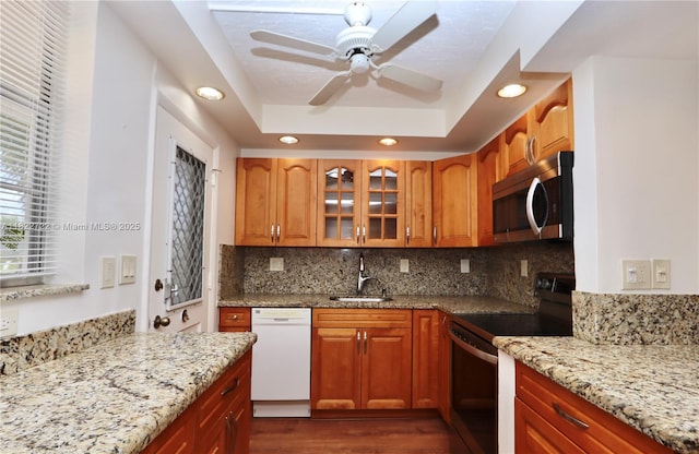 2920 Point E Dr Unit N208, Aventura, FL 33160 - kitchen featuring appliances with stainless steel finishes, dark wood-type flooring, light stone counters, recessed lighting, and a ceiling fan