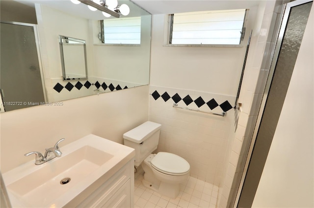 2920 Point E Dr Unit N208, Aventura, FL 33160 - bathroom featuring a shower stall, tile patterned floors, tile walls, vanity, and a wainscoted wall
