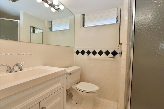 2920 Point E Dr Unit N208, Aventura, FL 33160 - bathroom with tile walls, a stall shower, tile patterned flooring, vanity, and a wainscoted wall