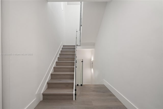 18955 Atlantic Blvd, Sunny Isles Beach, FL 33160 - stairs with wood finished floors and baseboards