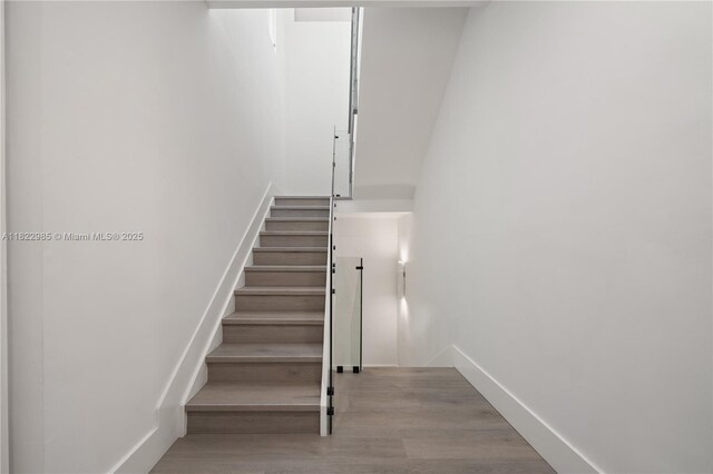 18955 Atlantic Blvd, Sunny Isles Beach, FL 33160 - stairs with wood finished floors and baseboards