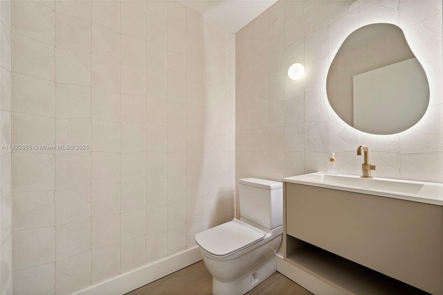 18955 Atlantic Blvd, Sunny Isles Beach, FL 33160 - bathroom featuring vanity, wood finished floors, and tile walls