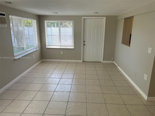 3818 Everglades Rd, Palm Beach Gardens, FL 33410 - foyer entrance featuring light tile patterned flooring and baseboards