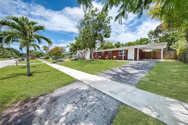 3818 Everglades Rd, Palm Beach Gardens, FL 33410 - view of front of property featuring asphalt driveway and a carport