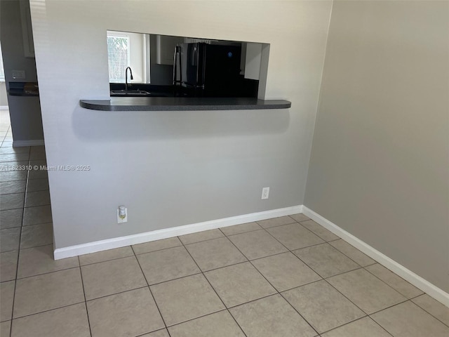3818 Everglades Rd, Palm Beach Gardens, FL 33410 - kitchen featuring freestanding refrigerator, tile patterned flooring, and dark countertops