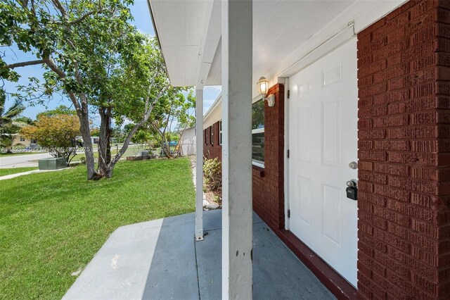 3818 Everglades Rd, Palm Beach Gardens, FL 33410 - doorway to property with a lawn