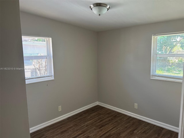 3818 Everglades Rd, Palm Beach Gardens, FL 33410 - spare room with plenty of natural light and dark wood-style floors