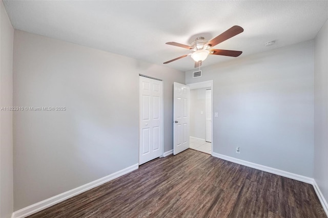 3818 Everglades Rd, Palm Beach Gardens, FL 33410 - unfurnished bedroom featuring dark wood-style flooring, a closet, and a ceiling fan