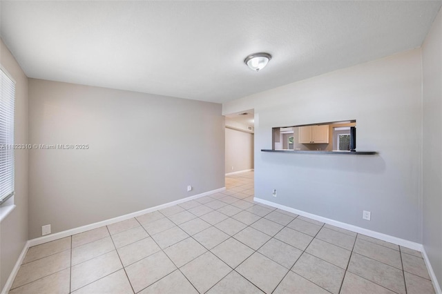 3818 Everglades Rd, Palm Beach Gardens, FL 33410 - spare room with light tile patterned flooring and baseboards