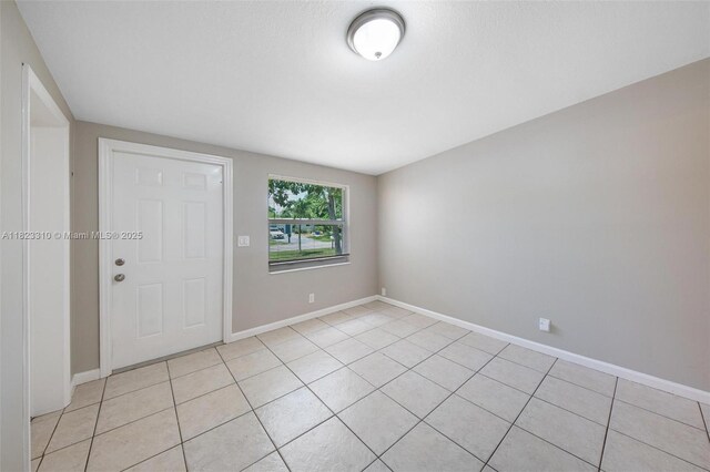 3818 Everglades Rd, Palm Beach Gardens, FL 33410 - foyer entrance featuring light tile patterned floors and baseboards