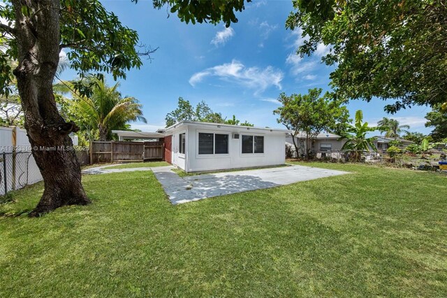 3818 Everglades Rd, Palm Beach Gardens, FL 33410 - rear view of house with a patio area and a fenced backyard