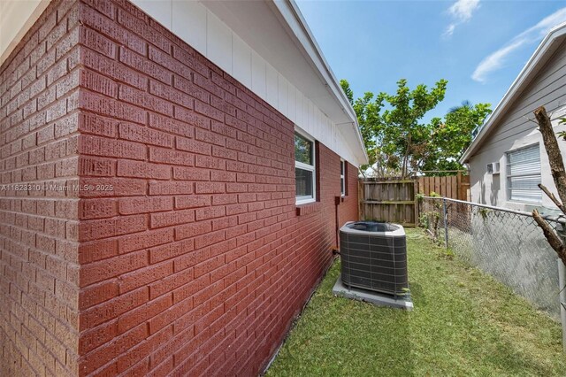 3818 Everglades Rd, Palm Beach Gardens, FL 33410 - view of side of property featuring a central air condition unit and brick siding