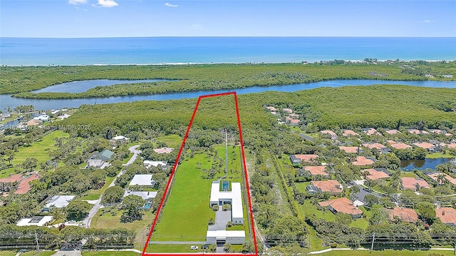 9741 SE Gomez Ave, Hobe Sound, FL 33455 - aerial perspective of suburban area featuring a nearby body of water and property parcel outlined