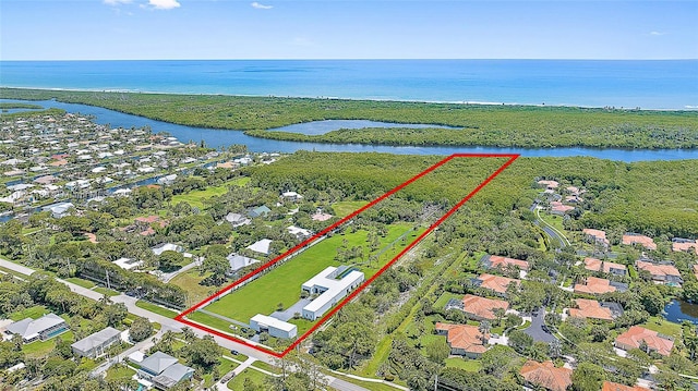 9741 SE Gomez Ave, Hobe Sound, FL 33455 - aerial perspective of suburban area featuring a large body of water and property boundaries highlighted