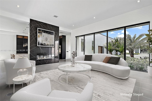 9741 SE Gomez Ave, Hobe Sound, FL 33455 - living area with a high end fireplace, recessed lighting, and tile patterned flooring