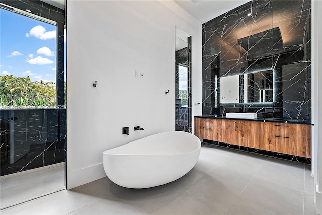 9741 SE Gomez Ave, Hobe Sound, FL 33455 - bathroom featuring vanity, a freestanding bath, tile patterned flooring, and tasteful backsplash