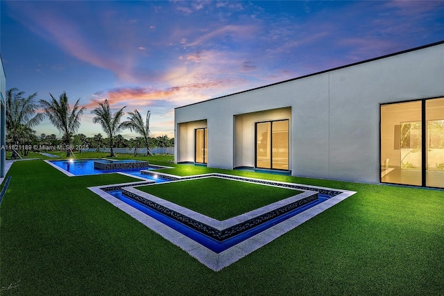 9741 SE Gomez Ave, Hobe Sound, FL 33455 - pool at dusk featuring an outdoor pool and a lawn