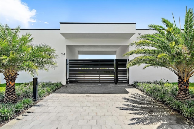 9741 SE Gomez Ave, Hobe Sound, FL 33455 - view of front facade featuring a gate and stucco siding
