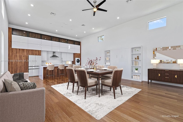 9741 SE Gomez Ave, Hobe Sound, FL 33455 - dining room featuring a high ceiling, ceiling fan, recessed lighting, and wood finished floors