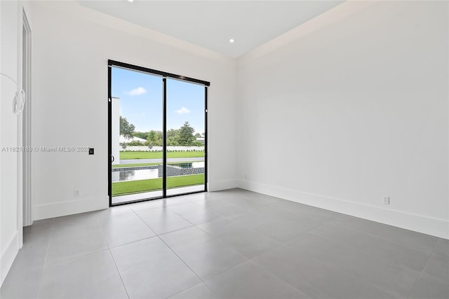9741 SE Gomez Ave, Hobe Sound, FL 33455 - tiled empty room featuring baseboards and a water view