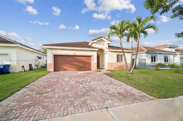 10870 SW 229th St, Miami, FL 33170 - mediterranean / spanish home featuring decorative driveway, stucco siding, a front lawn, a garage, and a tile roof