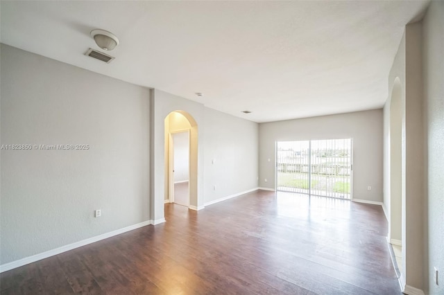 10870 SW 229th St, Miami, FL 33170 - spare room with arched walkways and dark wood-style floors